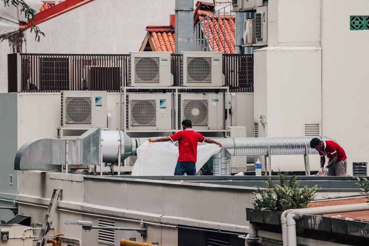 HVAC technicians servicing rooftop air conditioning units